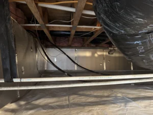 **Revised Alt Text:** A sealed crawlspace with a vapor barrier, insulated walls, and ventilation, highlighting EcoCrawls’ finished encapsulation.
