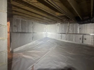 A clean crawl space in a Chapel Hill home after Eco Crawls' mold remediation, featuring vapor barriers and sealed walls for moisture control.