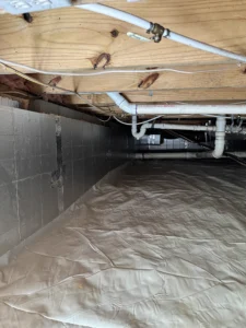 Clean, fully encapsulated crawlspace in Chapel Hill after mold remediation, featuring a sealed vapor barrier, dehumidifier system, and improved moisture protection under the home.
